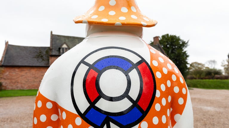 A statue of the Snowman™ gazes at the stable block at Baddesley Clinton, Warwickshire
